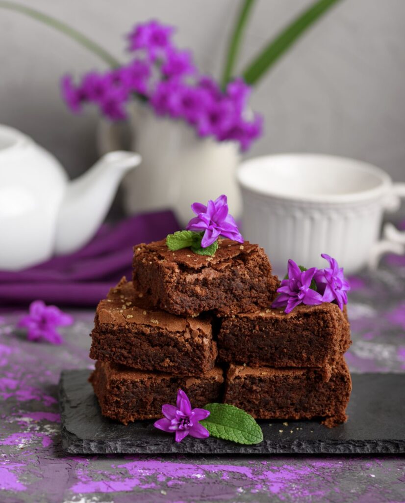 brownies as a dessert with one cup of tea and teapot